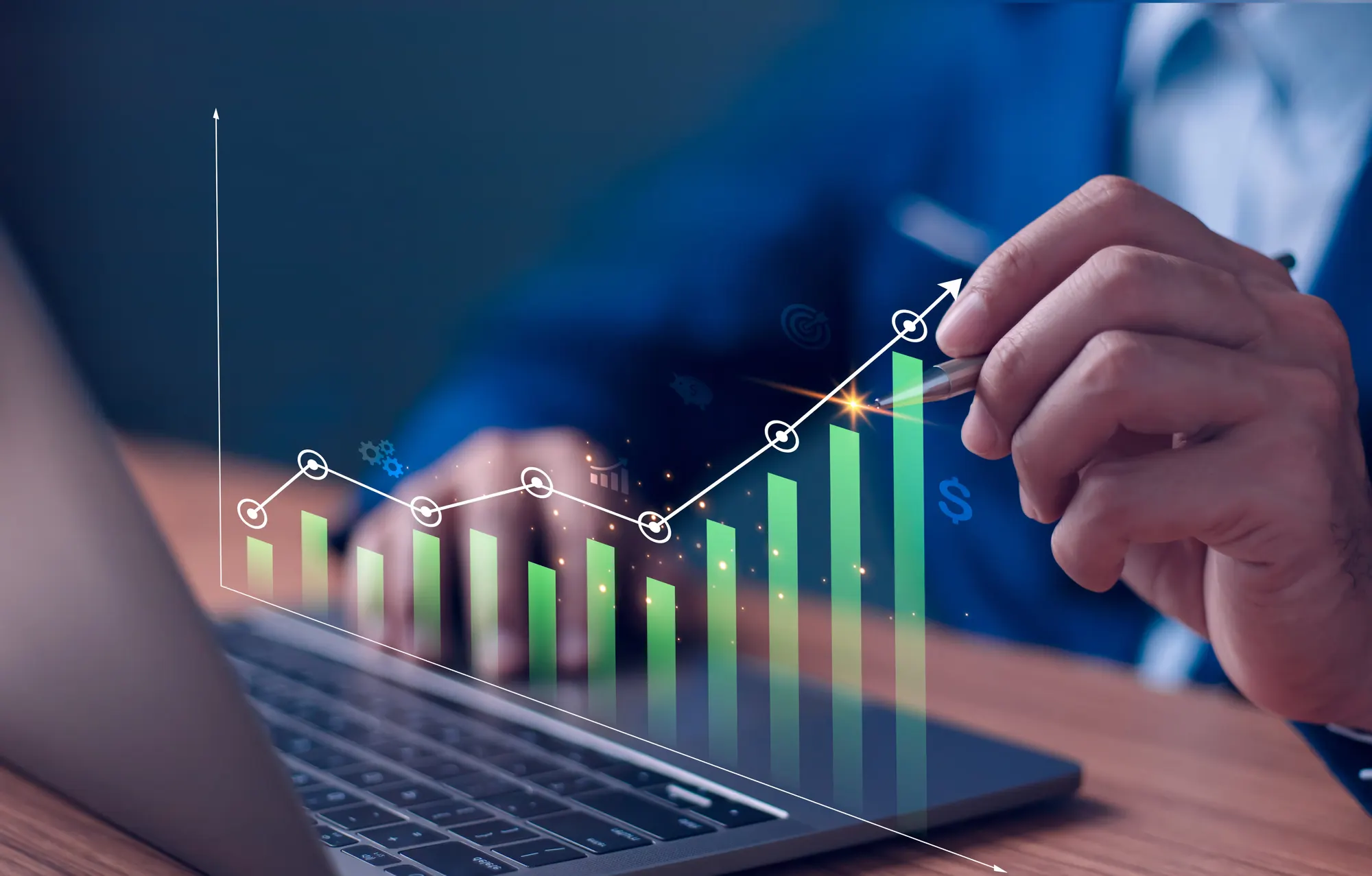 Businessman drawing an upward trending graph with green bars on a laptop screen indicating growth and financial success.