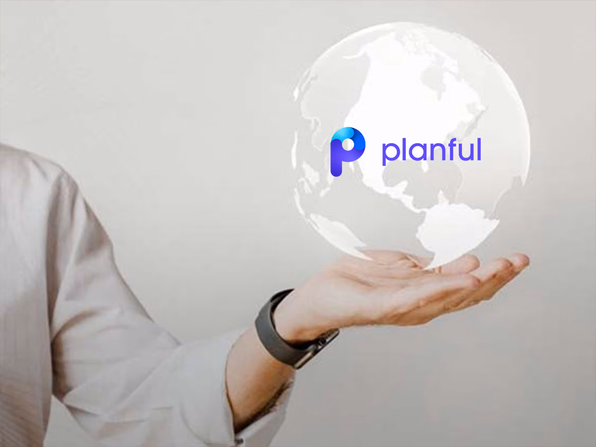 Person holding a transparent globe with the Planful logo displayed on it.