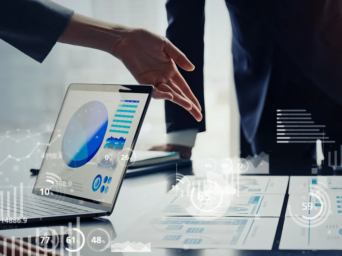 A finance leader reviewing planning dashboards and reports with a colleague.